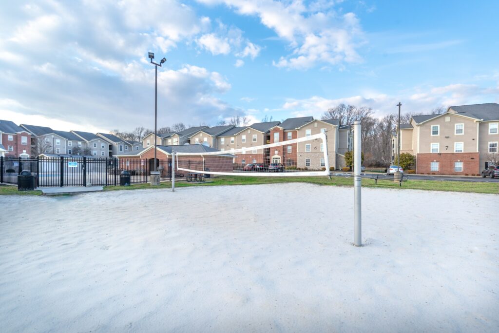 Sand volleyball court by the pool outside the apartment buildings