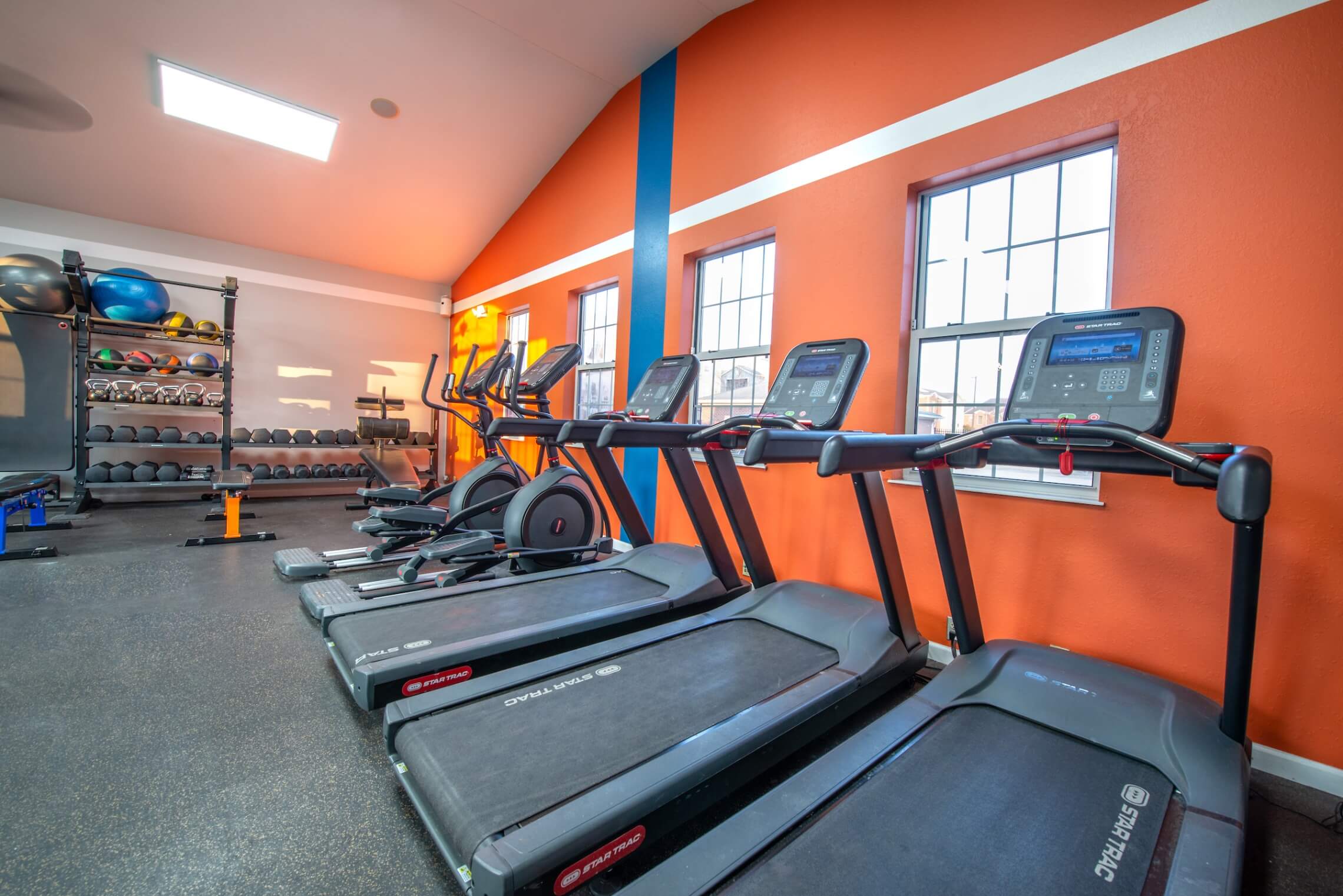 Fitness center with strength training equipment and cardio machines