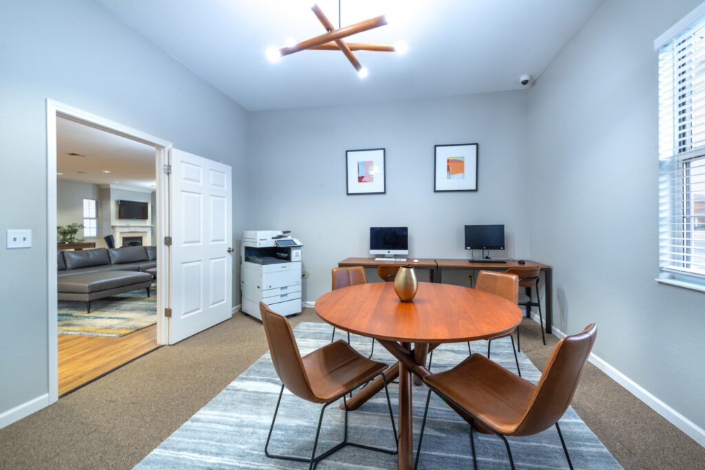 Private room with table, computers, and printer