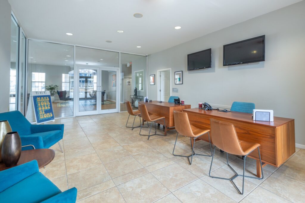 Leasing office reception desk with lounge chairs