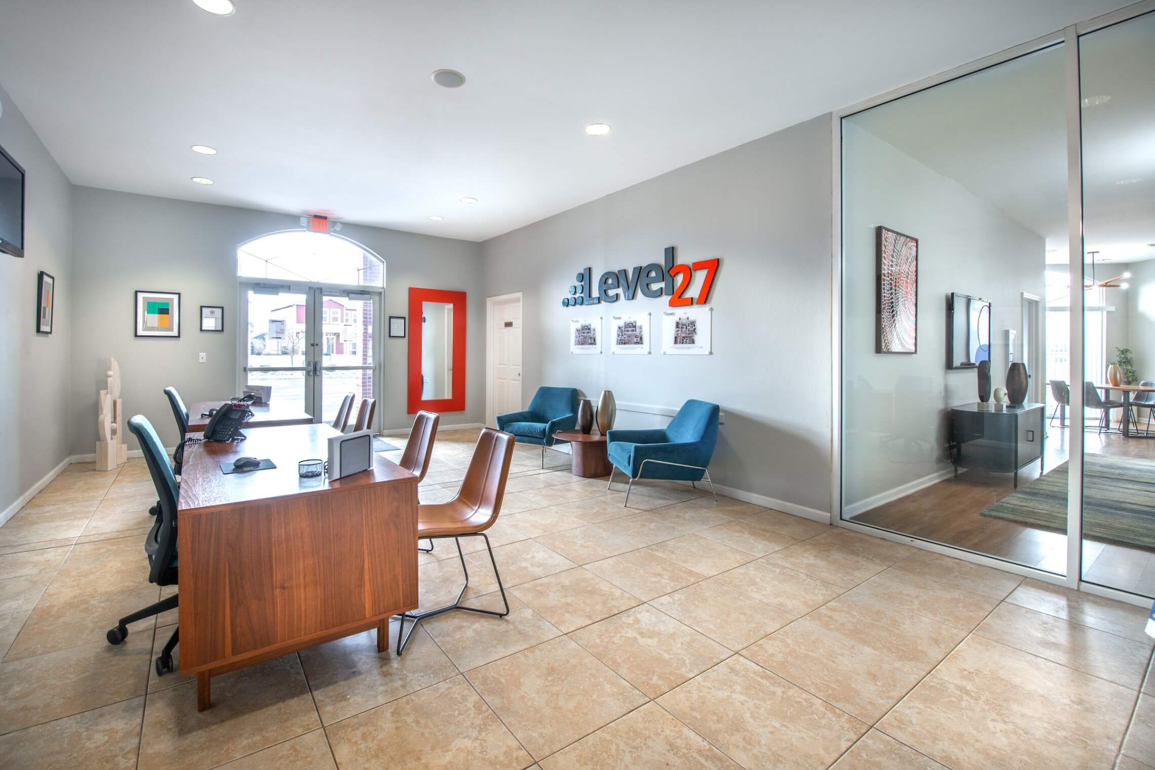 Leasing office reception desk with lounge chairs