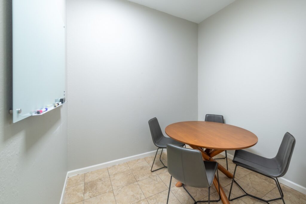 private room with table and whiteboard