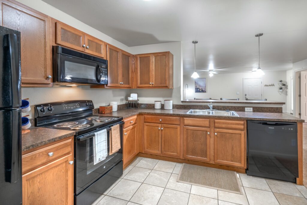 kitchen with black appliances and bar seating