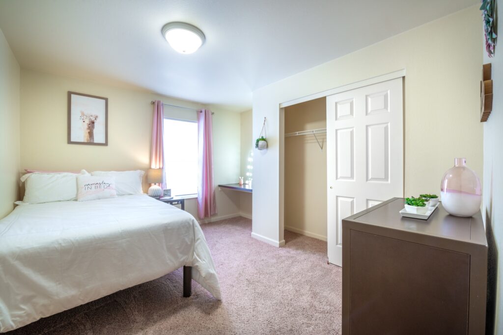 Bedroom with large window and built in desk