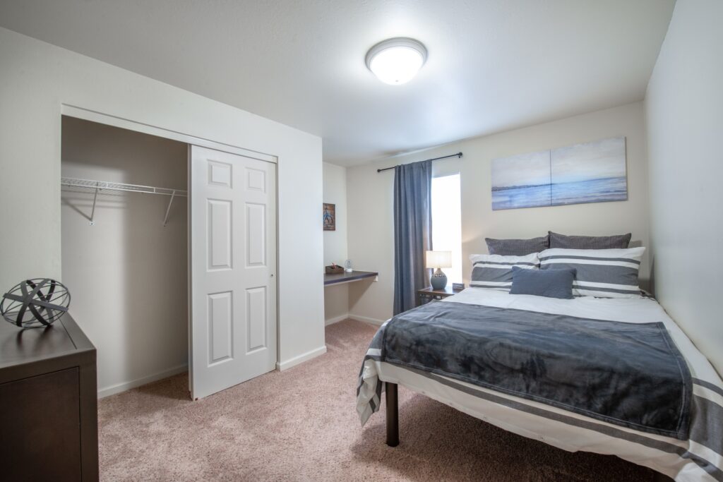 Bedroom with large window and built in desk