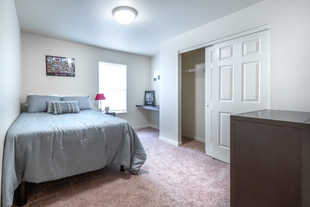 Bedroom with large window and built in desk