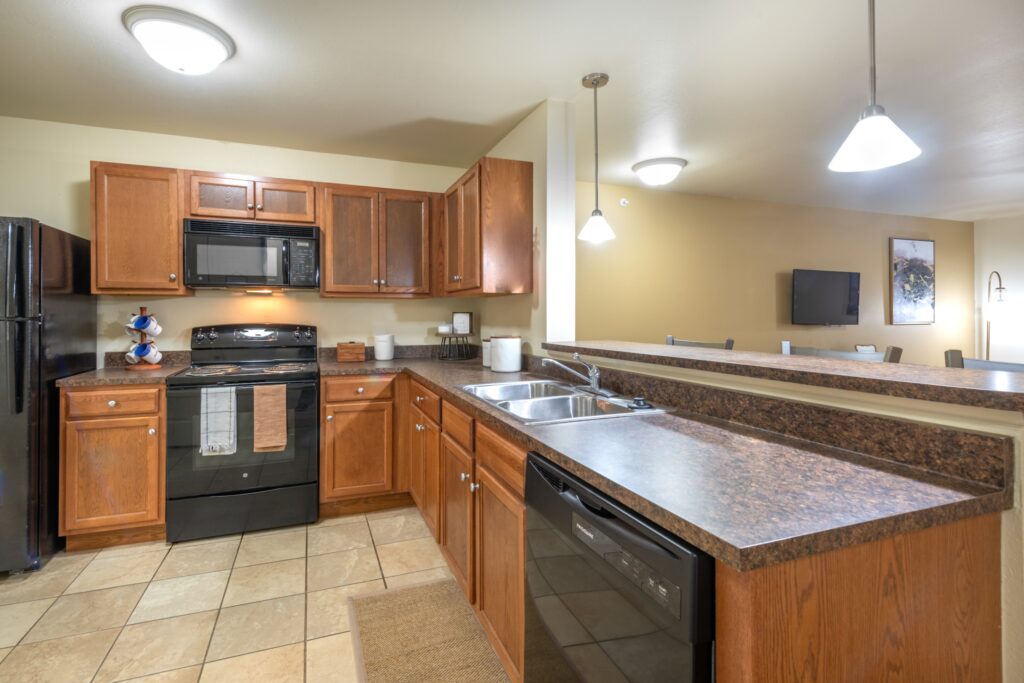 kitchen with black appliances and bar seating