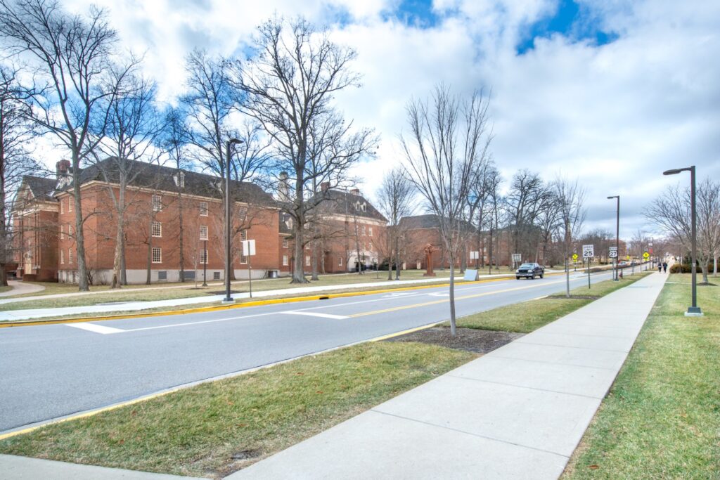 External view of Miami university, tree lined sidewalk outside large brick buildings