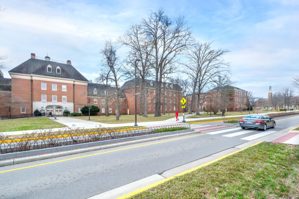 External view of Miami university, tree lined sidewalk outside large brick buildings